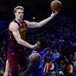 
              Cleveland Cavaliers' Lauri Markkanen, left, goes up for a shot against Philadelphia 76ers' Joel Embiid during the first half of an NBA basketball game, Friday, March 4, 2022, in Philadelphia. (AP Photo/Matt Slocum)
            