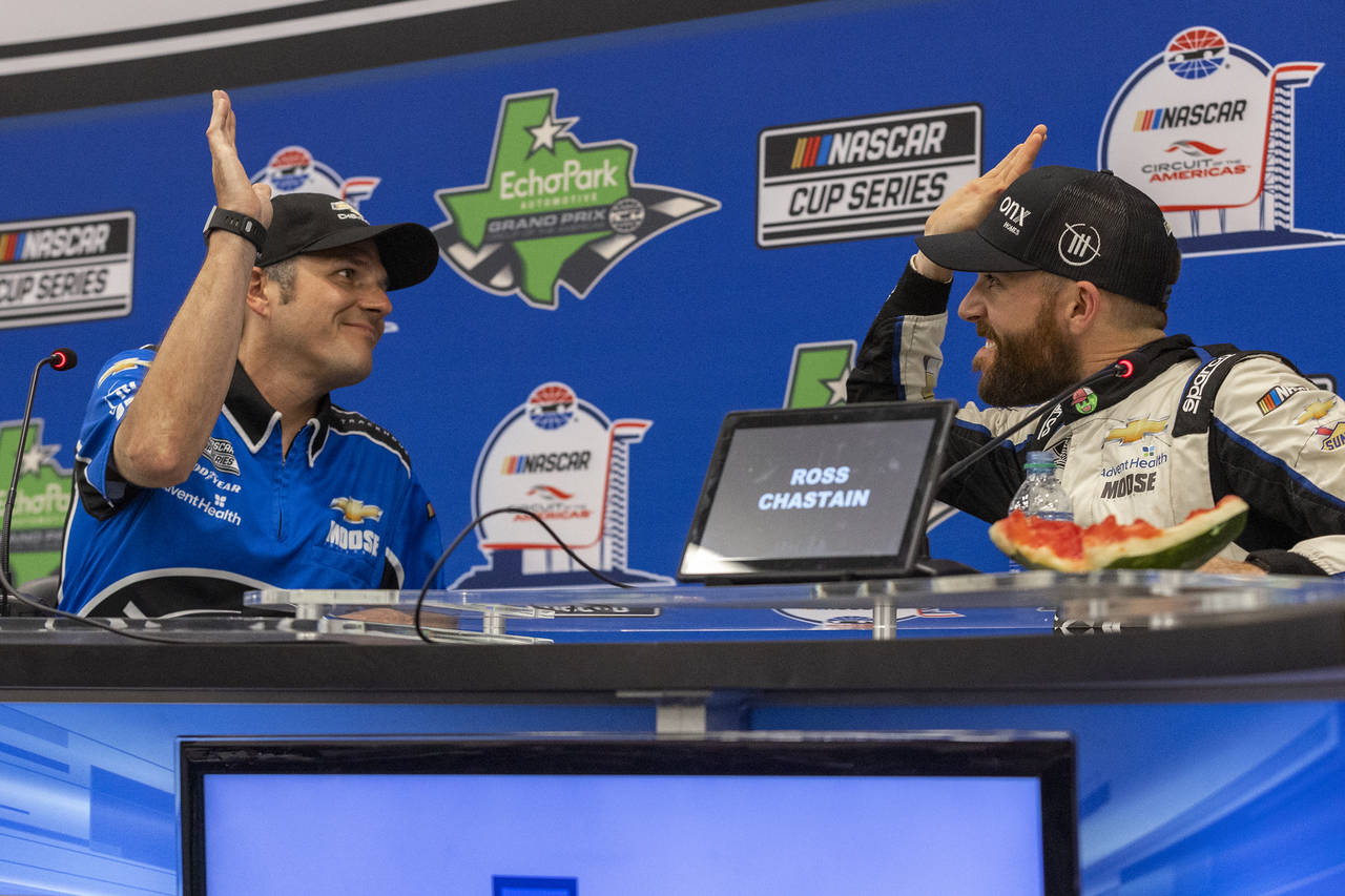 Crew chief Phil Surgen, left, shares a high-five with driver Ross Chastain during a post-race inter...