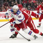 
              New York Rangers center Tyler Motte (64) shoots as Detroit Red Wings' Filip Hronek (17) defends in the third period of an NHL hockey game Wednesday, March 30, 2022, in Detroit. (AP Photo/Paul Sancya)
            