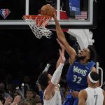 
              Minnesota Timberwolves center Karl-Anthony Towns (32) dunks over Oklahoma City Thunder forward Isaiah Roby, center, in the second half of an NBA basketball game Friday, March 4, 2022, in Oklahoma City. (AP Photo/Sue Ogrocki)
            