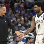 
              Brooklyn Nets coach Steve Nash, left, greets guard Kyrie Irving (11) during a timeout in the first half of the team's NBA basketball game against the Orlando Magic, Tuesday, March 15, 2022, in Orlando, Fla. (AP Photo/Phelan M. Ebenhack)
            