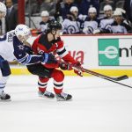 
              New Jersey Devils center Jack Hughes (86) fights for the puck against Winnipeg Jets defense Dylan DeMelo (2) during the first period of an NHL hockey game Thursday, March 10, 2022, in Newark, N.J. (AP Photo/Eduardo Munoz Alvarez)
            