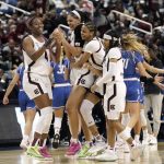 
              South Carolina forward Aliyah Boston (4) celebrates with teammates center Kamilla Cardoso, guard LeLe Grissett and guard Destanni Henderson, right, late in the second half of a college basketball game in the Elite 8 round of the NCAA tournament in Greensboro, N.C., Sunday, March 27, 2022. (AP Photo/Gerry Broome)
            
