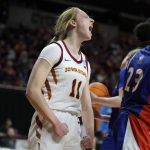 
              Iowa State guard Emily Ryan (11) reacts in front of Texas-Arlington guard Camryn Hawkins (23) after making a basket during the second half of a first-round game in the NCAA women's college basketball tournament, Friday, March 18, 2022, in Ames, Iowa. (AP Photo/Charlie Neibergall)
            