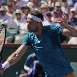 
              Grigor Dimitrov, of Bulgaria, returns a shot to Andrey Rublev, of Russia, at the BNP Paribas Open tennis tournament Friday, March 18, 2022, in Indian Wells, Calif. (AP Photo/Mark J. Terrill)
            