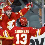 
              Calgary Flames' Elias Lindholm celebrates his goal against the Edmonton Oilers with Johnny Gaudreau during the first period of an NHL hockey game Saturday, March 26, 2022, in Calgary, Alberta. (Jeff McIntosh/The Canadian Press via AP)
            