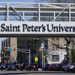 
              A sign displayed the name of Saint Peter's University in Jersey City, N.J., Monday, March 21, 2022. (AP Photo/Seth Wenig)
            