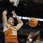 
              Texas's Christian Bishop dunks during the first half of a second-round NCAA college basketball tournament game against Purdue Sunday, March 20, 2022, in Milwaukee. (AP Photo/Jeffrey Phelps)
            
