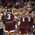 
              Texas A&M guard Wade Taylor IV (4) celebrates with guard Quenton Jackson (3) after the team defeated Auburn during an NCAA men's college basketball Southeastern Conference tournament game Friday, March 11, 2022, in Tampa, Fla. (AP Photo/Chris O'Meara)
            