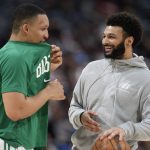 
              Boston Celtics forward Grant Williams, left, jokes with injured Denver Nuggets guard Jamal Murray as the teams warm up for the second half of an NBA basketball game Sunday, March 20, 2022, in Denver. (AP Photo/David Zalubowski)
            