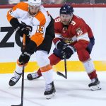 
              Philadelphia Flyers center Kevin Hayes (13) and Florida Panthers center Sam Bennett (9) go after the puck during the second period of an NHL hockey game Thursday, March 10, 2022, in Sunrise, Fla. (AP Photo/Marta Lavandier)
            
