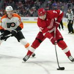
              Detroit Red Wings center Oskar Sundqvist (70) backhands the puck as Philadelphia Flyers right wing Owen Tippett (74) defends in the second period of an NHL hockey game Tuesday, March 22, 2022, in Detroit. (AP Photo/Paul Sancya)
            