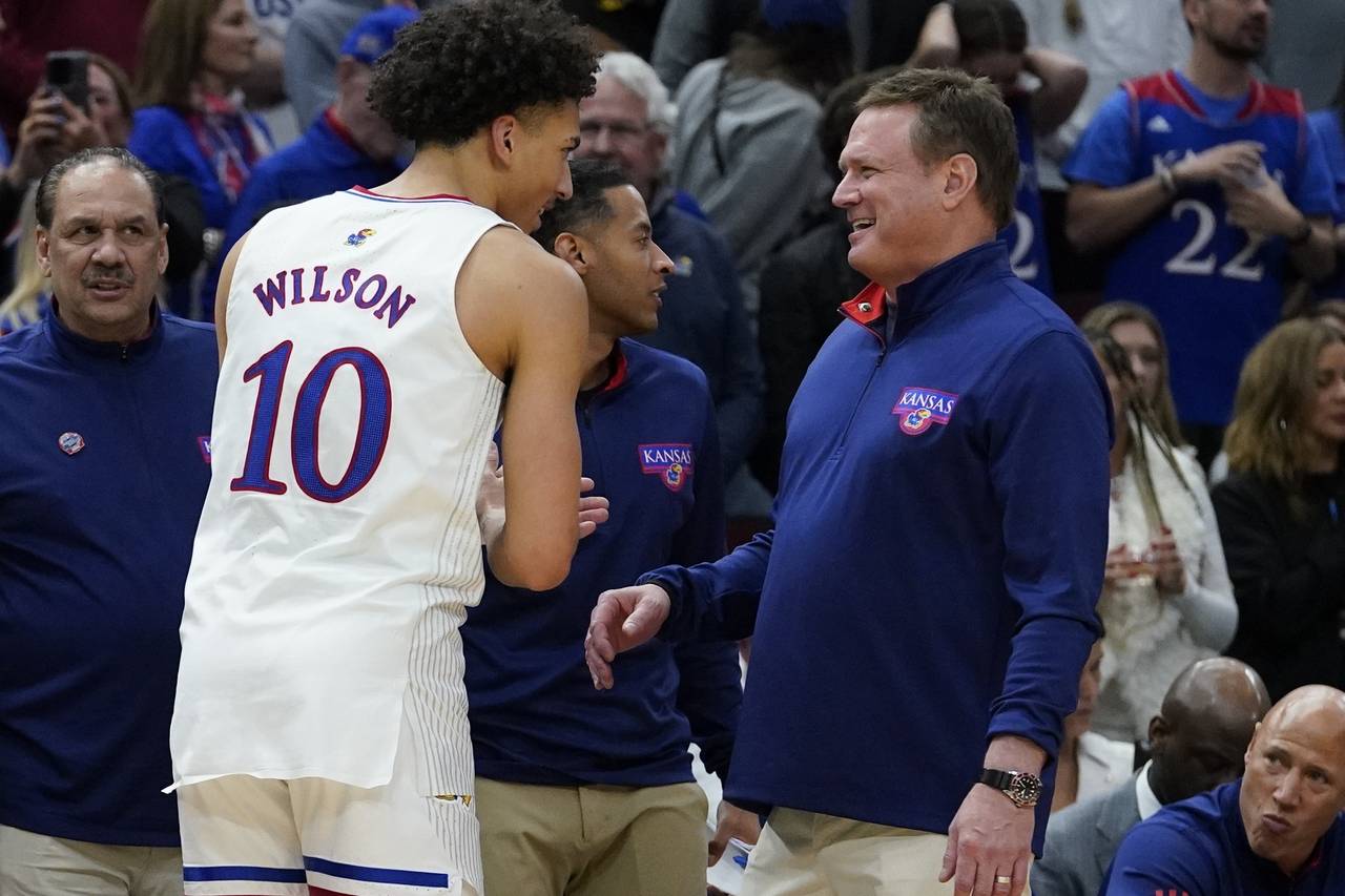 Kansas head coach Bill Self smiles with Jalen Wilson during the second half of a college basketball...