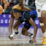 
              Kentucky's Rhyne Howard stumbles after the ball after colliding with LSU's Khayla Pointer, right, in the second half of an NCAA college basketball game at the women's Southeastern Conference tournament Friday, March 4, 2022, in Nashville, Tenn. (AP Photo/Mark Humphrey)
            
