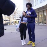 
              Saint Peter's University basketball player Clarence Rupert poses for a picture with another student and fan, Natalia Guillen, on the St. Peter's University campus in Jersey City, N.J., Monday, March 21, 2022. (AP Photo/Seth Wenig)
            