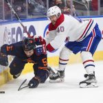 
              Montreal Canadiens' Joel Armia (40) checks Edmonton Oilers' Cody Ceci (5) during first-period NHL hockey game action in Edmonton, Alberta, Saturday, March 5, 2022. (Jason Franson/The Canadian Press via AP)
            