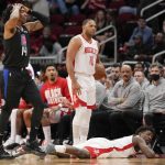 
              Los Angeles Clippers guard Terance Mann (14) reacts after being called for a foul on Houston Rockets forward Jae'Sean Tate, bottom right, during the second half of an NBA basketball game, Sunday, Feb. 27, 2022, in Houston. (AP Photo/Eric Christian Smith)
            