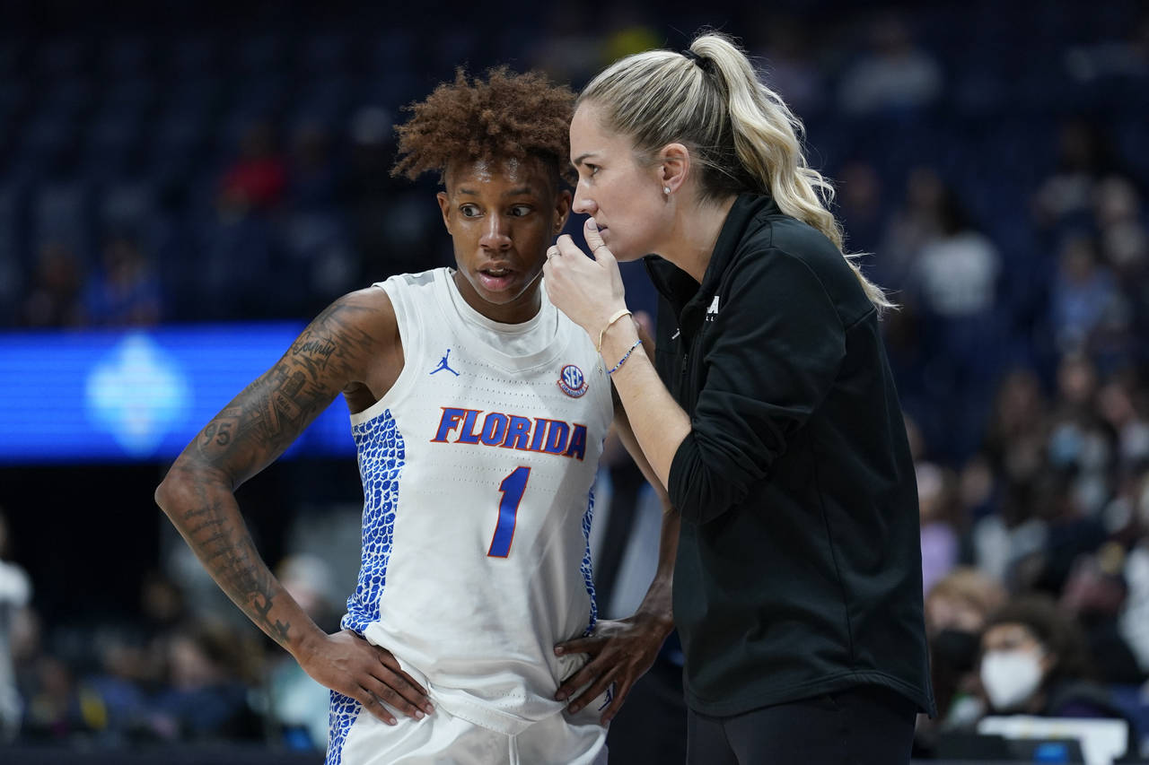 Florida head coach Kelly Rae Finley talks with Kiara Smith (1) in the first half of an NCAA college...
