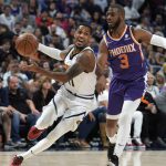 
              Denver Nuggets guard Monte Morris, left, drives past Phoenix Suns guard Chris Paul during the first half of an NBA basketball game Thursday, March 24, 2022, in Denver. (AP Photo/David Zalubowski)
            