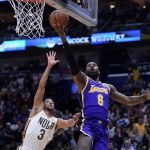 
              Los Angeles Lakers forward LeBron James (6) goes to the basket against New Orleans Pelicans guard CJ McCollum (3) in the first half of an NBA basketball game in New Orleans, Sunday, March 27, 2022. (AP Photo/Gerald Herbert)
            