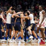 
              Notre Dame players celebrate after defeating Rutgers 89-87 in double overtime in a First Four game in the NCAA men's college basketball tournament, early Thursday, March 17, 2022, in Dayton, Ohio. (AP Photo/Jeff Dean)
            
