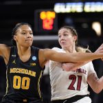 
              Michigan forward Naz Hillmon (00) defends Louisville forward Emily Engstler (21) during the first half of a college basketball game in the Elite 8 round of the NCAA women's tournament Monday, March 28, 2022, in Wichita, Kan. (AP Photo/Jeff Roberson)
            