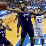 
              TCU center Eddie Lampkin (4) beats Kansas forward David McCormack (33) to a rebound during the first half of an NCAA college basketball game Thursday, March 3, 2022, in Lawrence, Kan. (AP Photo/Charlie Riedel)
            