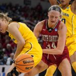 
              South Dakota's Hannah Sjerven (34) and Michigan's Maddie Nolan watch a loose ball during the first half of a college basketball game in the Sweet 16 round of the NCAA women's tournament Saturday, March 26, 2022, in Wichita, Kan. (AP Photo/Jeff Roberson)
            