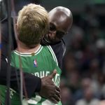 
              Heather Walker, left, Boston Celtics vice president of public relations, receives a hug from former Celtics player Kevin Garnett, right, following a Heroes Among Us award ceremony for Walker in the first half of an NBA basketball game against the Dallas Mavericks, Sunday, March 13, 2022, in Boston. Walker received the award following her treatment for a brain tumor. (AP Photo/Steven Senne)
            