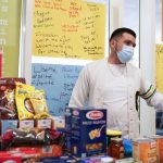 
              Student Evaristo Solano-Lopez organizes items donated to food drive at St. Peter's University in Jersey City, N.J., Monday, March 21, 2022. (AP Photo/Seth Wenig)
            