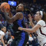 
              Kentucky's Dre'una Edwards, center, shoots against South Carolina's Brea Beal, right, in the first half of the NCAA women's college basketball Southeastern Conference tournament championship game Sunday, March 6, 2022, in Nashville, Tenn. (AP Photo/Mark Humphrey)
            