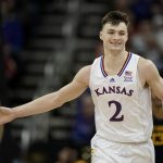 
              Kansas guard Christian Braun celebrates after a basket during the first half of an NCAA college basketball game against West Virginia in the quarterfinal round of the Big 12 Conference tournament in Kansas City, Mo., Thursday, March 10, 2022. (AP Photo/Charlie Riedel)
            