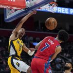 
              Indiana Pacers guard Tyrese Haliburton (0) dunks on Detroit Pistons guard Killian Hayes (7) in the second half of an NBA basketball game in Detroit, Friday, March 4, 2022. (AP Photo/Paul Sancya)
            