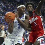 
              Kentucky's Oscar Tshiebwe, left, is pressured by Mississippi's Nysier Brooks (3) during the first half of an NCAA college basketball game in Lexington, Ky., Tuesday, March 1, 2022. (AP Photo/James Crisp)
            