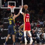
              Atlanta Hawks guard Trae Young (11) shoots a 3-point basket during the second half of an NBA basketball game against the Indiana Pacers, Sunday, March 13, 2022, in Atlanta. (AP Photo/Hakim Wright Sr.)
            