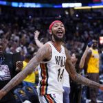 
              New Orleans Pelicans forward Brandon Ingram (14) celebrates after hugging his father Donald Ingram, left, after defeating the Los Angeles Lakers in an NBA basketball game in New Orleans, Sunday, March 27, 2022. The Pelicans won 116-108. (AP Photo/Gerald Herbert)
            