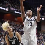 
              Connecticut's Christyn Williams shoots ahead of Georgetown's Kaylin West (10) during the first half of an NCAA college basketball game in the quarterfinals of the Big East Conference tournament at Mohegan Sun Arena, Saturday, March 5, 2022, in Uncasville, Conn. (AP Photo/Jessica Hill)
            