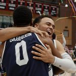 
              Yale's Azar Swain, facing, hugs teammate Jalen Gabbidon (0) after defeating Princeton in the NCAA Ivy League men's college basketball championship game, Sunday, March 13, 2022, in Cambridge, Mass. (AP Photo/Mary Schwalm)
            