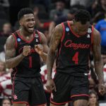 
              Houston guard Taze Moore, right, celebrates their win against Arizona with guard Jamal Shead during the second half of a college basketball game in the Sweet 16 round of the NCAA tournament on Thursday, March 24, 2022, in San Antonio. (AP Photo/David J. Phillip)
            