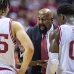 
              Indiana head coach Mike Woodson, center, talks with the players during a break in the second half of an NCAA college basketball game against Rutgers, Wednesday, March 2, 2022, in Bloomington, Ind. (AP Photo/Doug McSchooler)
            