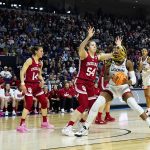 
              Connecticut forward Aaliyah Edwards (3) goes to the basket against Indiana forward Mackenzie Holmes (54) during the second quarter of a college basketball game in the Sweet Sixteen round of the NCAA women's tournament, Saturday, March 26, 2022, in Bridgeport, Conn. (AP Photo/Frank Franklin II)
            