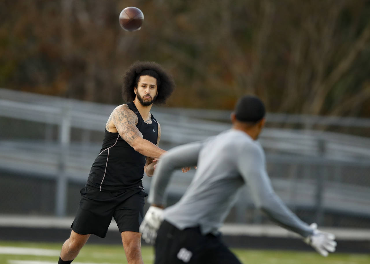 FILE - Free agent quarterback Colin Kaepernick participates in a workout for NFL football scouts an...