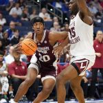 
              Mississippi State forward Derek Fountain (20) drives around South Carolina forward Wildens Leveque (15) during the first half of an NCAA men's college basketball game at the Southeastern Conference tournament in Tampa, Fla., Thursday, March 10, 2022. (AP Photo/Chris O'Meara)
            