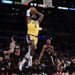 
              Los Angeles Lakers' LeBron James (6) goes up for a dunk during first half of an NBA basketball game against the Toronto Raptors, Monday, March 14, 2022, in Los Angeles. (AP Photo/Jae C. Hong)
            