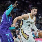 
              New Orleans Pelicans center Willy Hernangomez (9) moves to the lane past Charlotte Hornets center Montrezl Harrell, left, during the first half of an NBA basketball game on Monday, March 21, 2022, in Charlotte, N.C. (AP Photo/Rusty Jones)
            