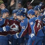 
              Colorado Avalanche left wing Gabriel Landeskog, third from left, is congratulated for his goal against the Calgary Flames by defensemen Devon Toews and Cale Makar, center Nazem Kadri and right wing Valeri Nichushkin, from left, during the first period of an NHL hockey game Saturday, March 5, 2022, in Denver. (AP Photo/David Zalubowski)
            