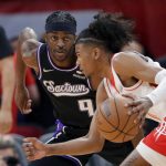 
              Houston Rockets guard Jalen Green, right, drives around Sacramento Kings forward Justin Holiday (9) during the first half of an NBA basketball game Wednesday, March 30, 2022, in Houston. (AP Photo/Michael Wyke)
            