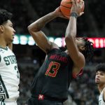 
              Maryland guard Hakim Hart (13) is fouled by Michigan State guard Jaden Akins (3) during the first half of an NCAA college basketball game, Sunday, March 6, 2022, in East Lansing, Mich. (AP Photo/Carlos Osorio)
            