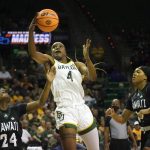
              Baylor center Queen Egbo (4) drives past Hawaii defenders Nae Nae Calhoun (24) and Nnenna Orji (14) during the second half of a college basketball game in the first round of the NCAA tournament in Waco, Texas, Friday, March 18, 2022. Baylor won 89-49. (AP Photo/LM Otero)
            