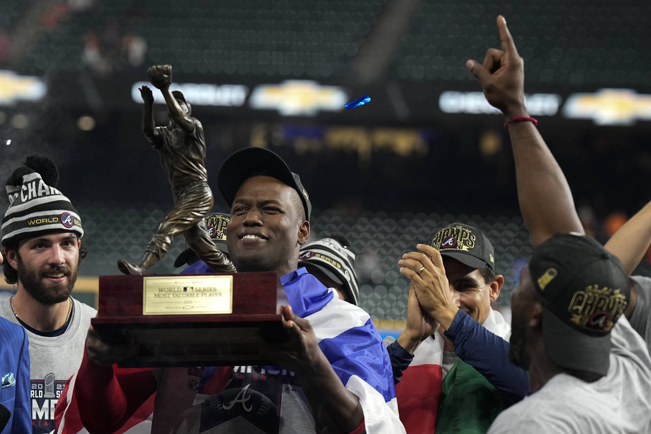 FILE - Atlanta Braves designated hitter Jorge Soler holds up the MVP trophy after winning baseball'...